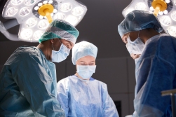 surgery, medicine and people concept - group of surgeons at oper